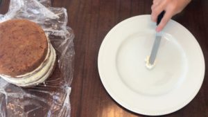 attach cake to plate with some buttercream how to travel with a cake in your suitcase