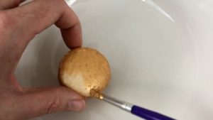 paint the top and sides of macarons gold with gold luster dust paint for edible gold cakes