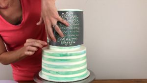 pin stencil into cake to wrap tightly for edible gold cakes