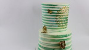 striped cake with gold stencil and gold butterflies for 20 ways to decorate edible gold cakes