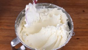 check buttercream consistency by tapping spatula on bowl