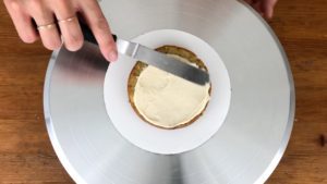 spread frosting on your cake before adding cookie dough disc