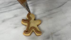 pipe outline on gingerbread man EASY Christmas Cookies