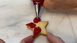 pipe poinsettia on star cookie EASY Christmas Cookies