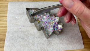 press sprinkles into melted chocoalte in cookie cutter 6 sprinkle christmas cake decorating ideas