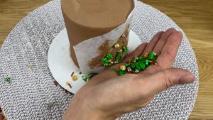 press sprinkles onto cake using homemade stencil 6 sprinkle christmas cake decorating ideas