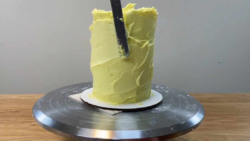 aim for an even thickness of frosting for straight sides and smooth frosting How to Make a Birthday Cake