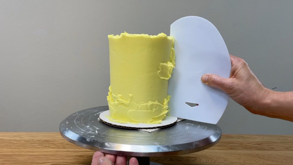 scrape with frosting smoother until frosting is smooth How to Make a Birthday Cake