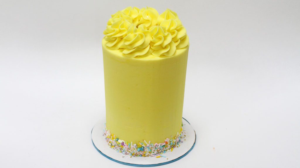 tall brithday cake with sprinkles and frosting swirls how to make a birthday cake