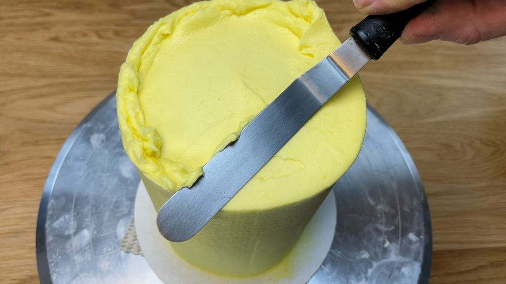 tidy up top edge with offset spatula How to Make a Birthday Cake