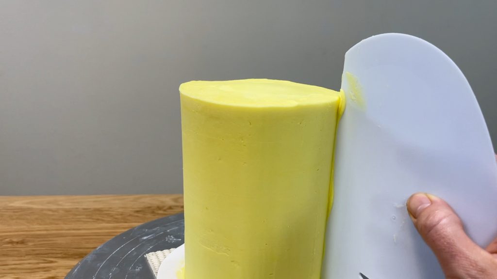 use frosting smoother to flatten bulge in frosting How to Make a Birthday Cake