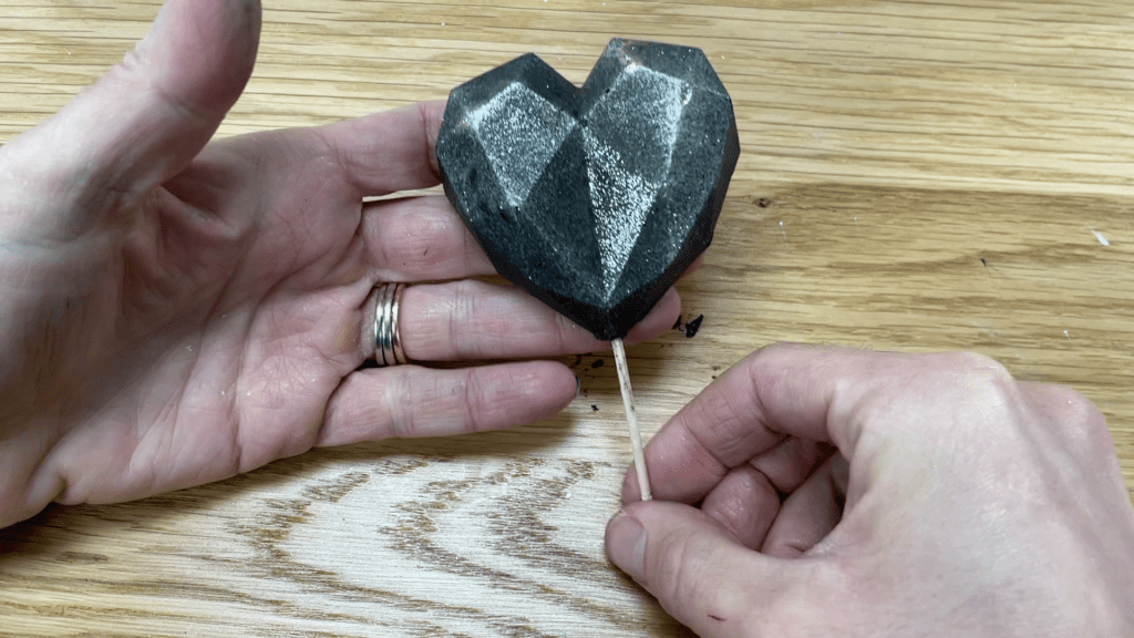 poke toothpick into chocolate geometric heart How to Make a Galaxy Cake