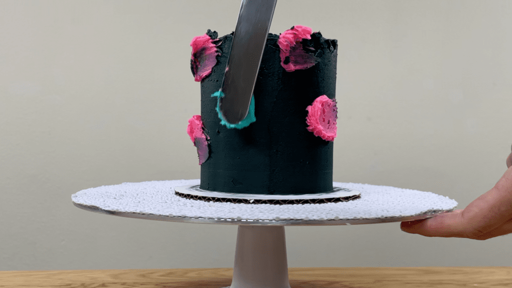 spread colourful frosting onto black buttercream How to Make a Galaxy Cake