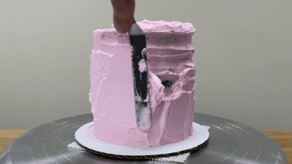 spread more frosting over exposed cake and scrape again with cake comb 10 Cake Fails and How to Fix Them