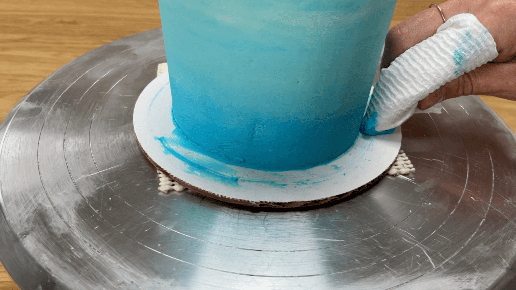 wipe buttercream smudges off cake board after chilling cake 10 Cake Fails and How to Fix Them