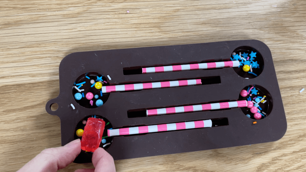 arrange paper straws and sprinkles in lollipop mold and add a hard candy like a jolly rancher 5 Cake Hacks to WOW!