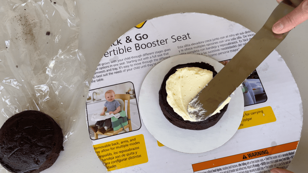 center cake on cake board and alternate filling and cake to assemble cake How To Transport A Cake 2000 Miles