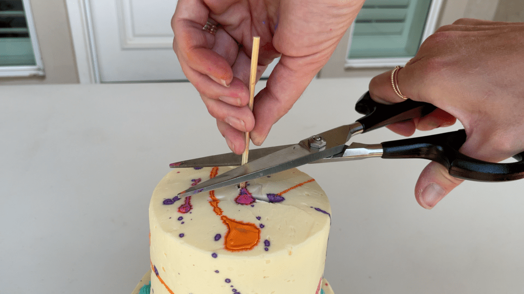 cut central dowel stick to the height of the tier cake How To Transport A Cake 2000 Miles