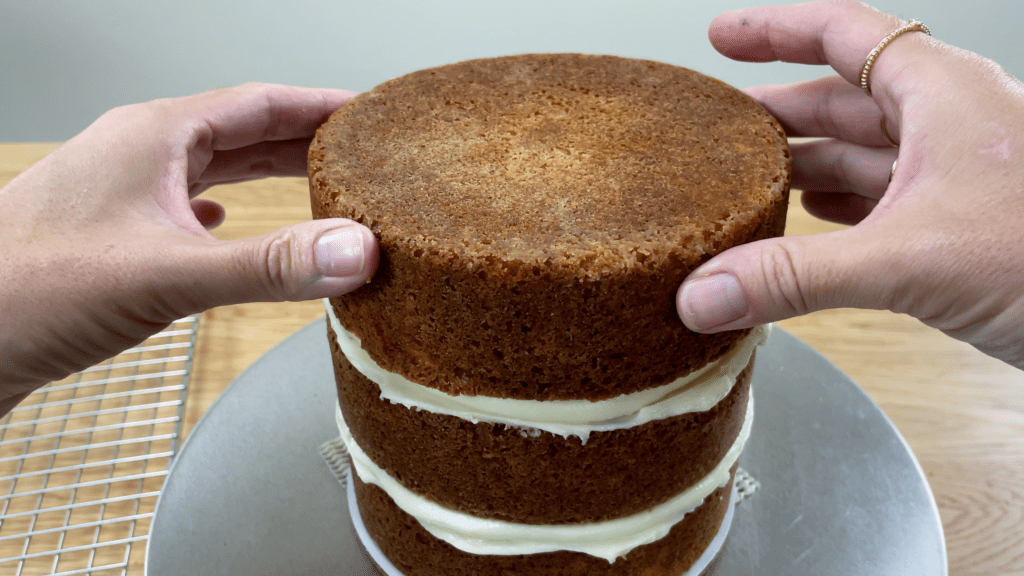 place top layer on cake and make sure its straight How To Transport A Cake 2000 Miles