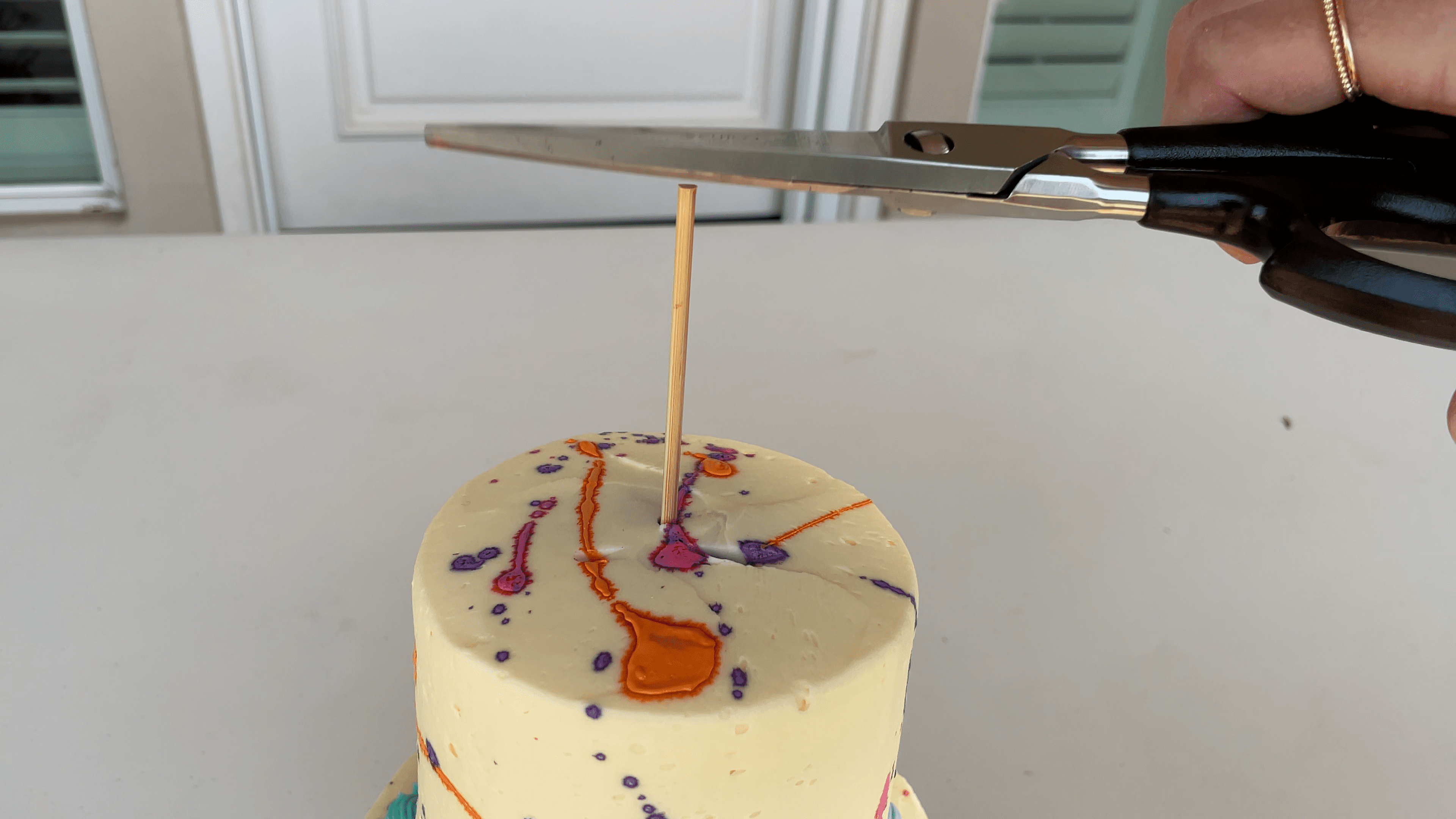 push central dowel stick through tier cake How To Transport A Cake 2000 Miles