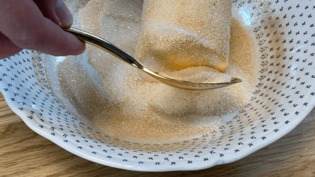 spoon gold sugar glitter over top of cake gold cakes 3 ways