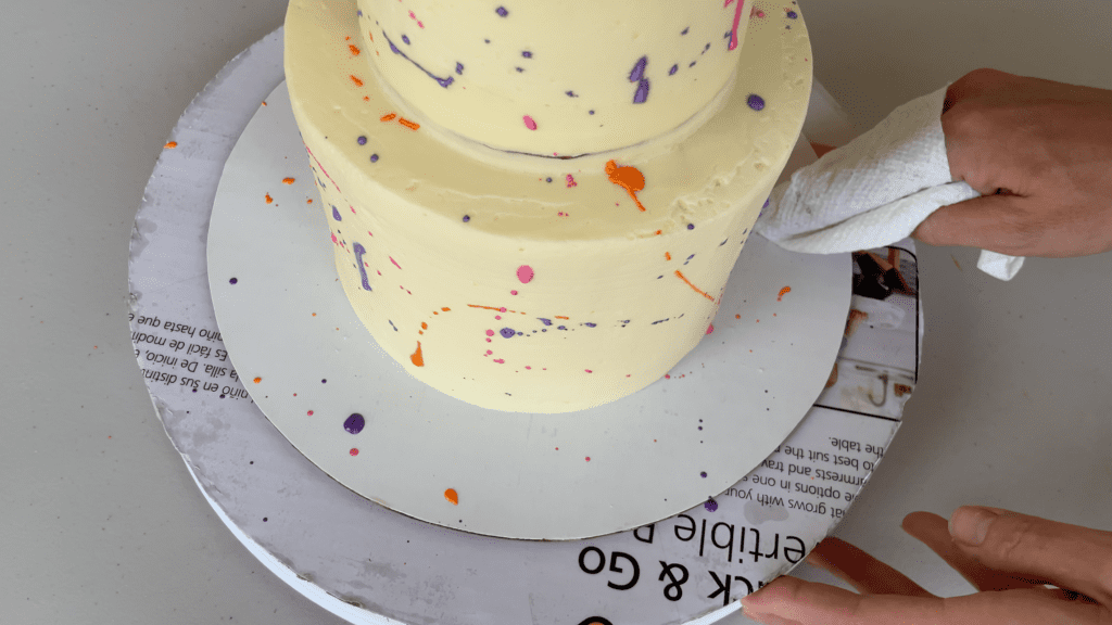 wipe smudges off cake board with paper towel How To Transport A Cake 2000 Miles