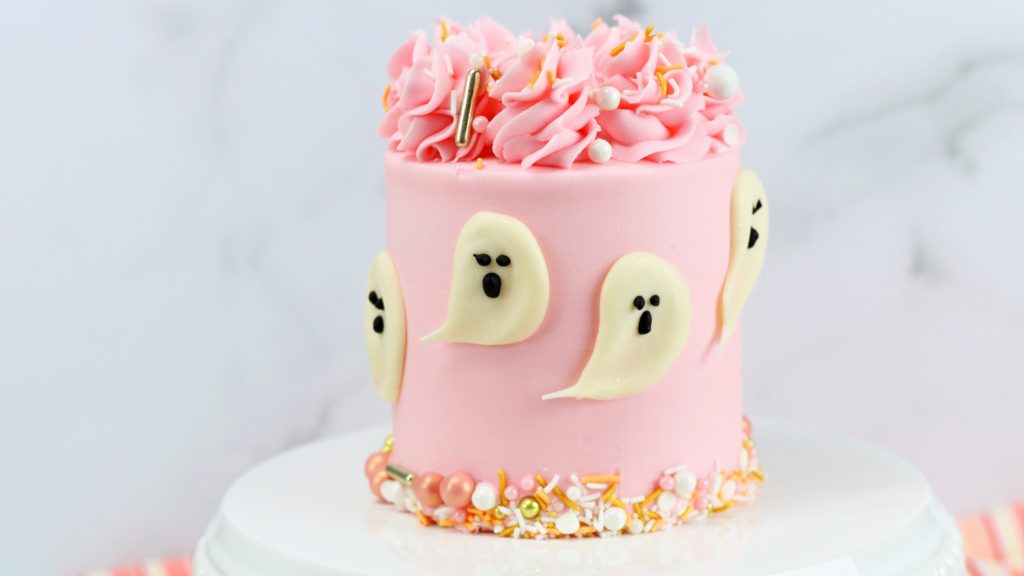 pink halloween cake with chocolate ghosts 10 Halloween Cake Hacks