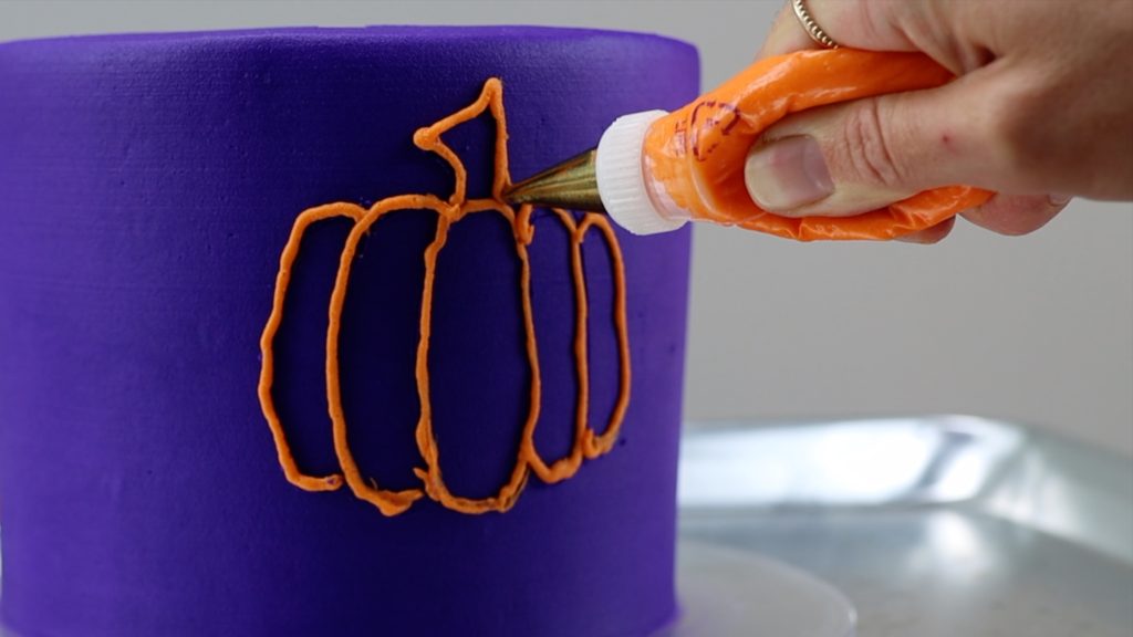 pipe design onto cake over outline 10 Halloween Cake Hacks