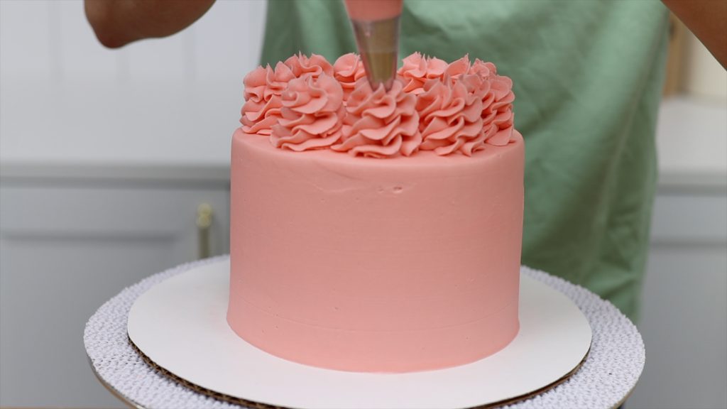 piping swirls onto a cake 10 Tips for your First Cake