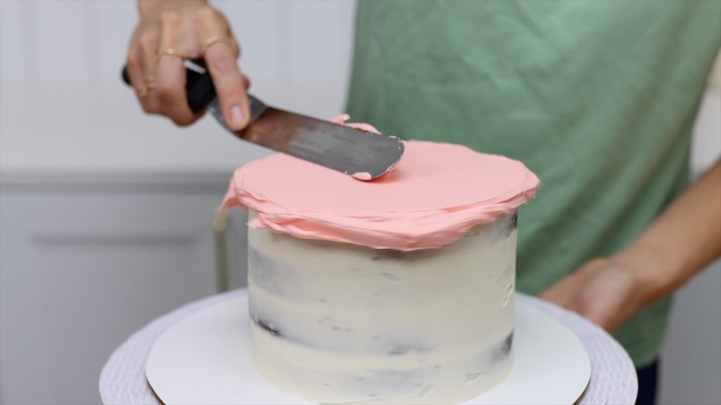 smoothing the frosting on top of cake 10 Tips for your First Cake