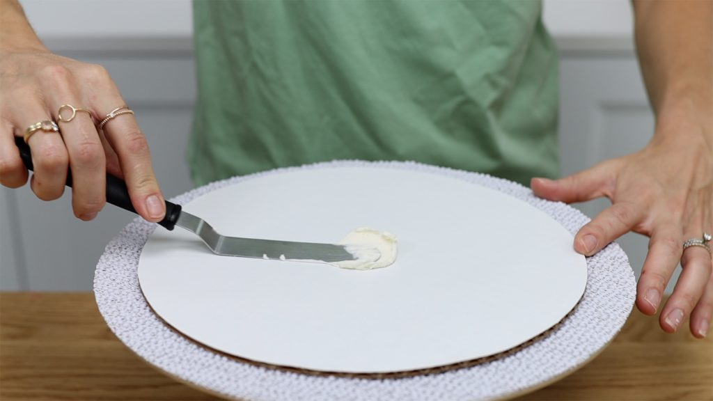 spread or pipe buttercream onto middle of cake board to attach cake 10 Tips for your First Cake