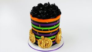 Striped Halloween Cake With Gold Buttercream Pumpkins and gold sprinkles