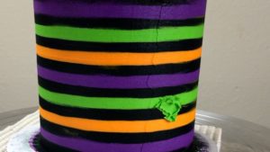 fill in air pockets with more frosting Striped Halloween Cake With Gold Buttercream Pumpkins