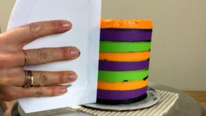 first scrape with frosting smoother blurs colours on Striped Halloween Cake
