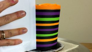 neat stripes at the end Striped Halloween Cake With Gold Buttercream Pumpkins