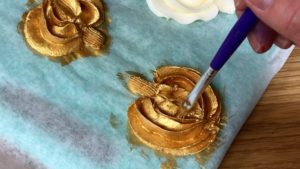 painting gold pumpkins with gold luster dust mixed with vodka
