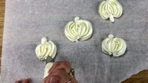 piped buttercream pumpkins for halloween cake
