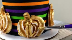 touch up gold buttercream pumpkins with more gold paint