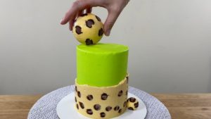attach leopard print chocolate to cake with a dot of buttercream or chocolate for trendy neon leopard print cake