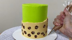 attach leopard print chocolates to cake with a dot of buttercream or chocolate for trendy neon leopard print cake