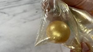 gold chocolate sphere decoration for trendy neon leopard print cake