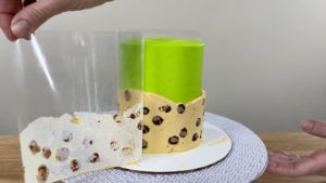 peel acetate off trendy neon leopard print cake to reveal leopard print frosting