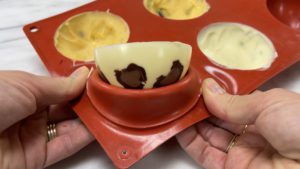 push leopard print chocolate spheres out of mold for trendy neon leopard print cake