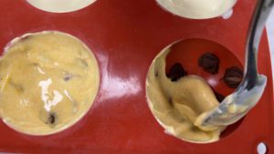 spoon chocolate into sphere mold over leopard print spots for trendy neon leopard print cake