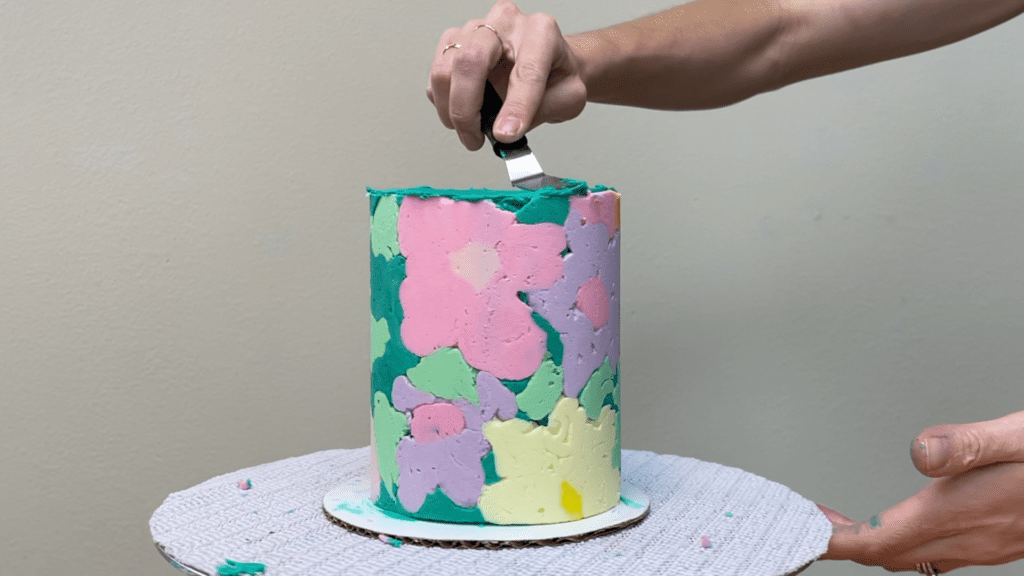 spread frosting on top of cake and smooth how to transfer any design onto a cake