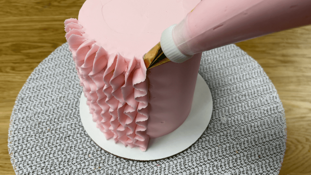 pipie ruffles above top edge of cake to tidy up later 5 Cakes You Can Decorate in 5 Minutes