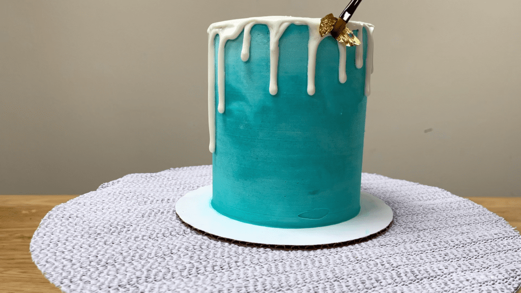 press gold leaf into a drip thats set How To Use Gold Leaf On Cakes