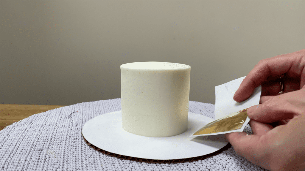 pull back gold leaf backing paper to open How To Use Gold Leaf On Cakes