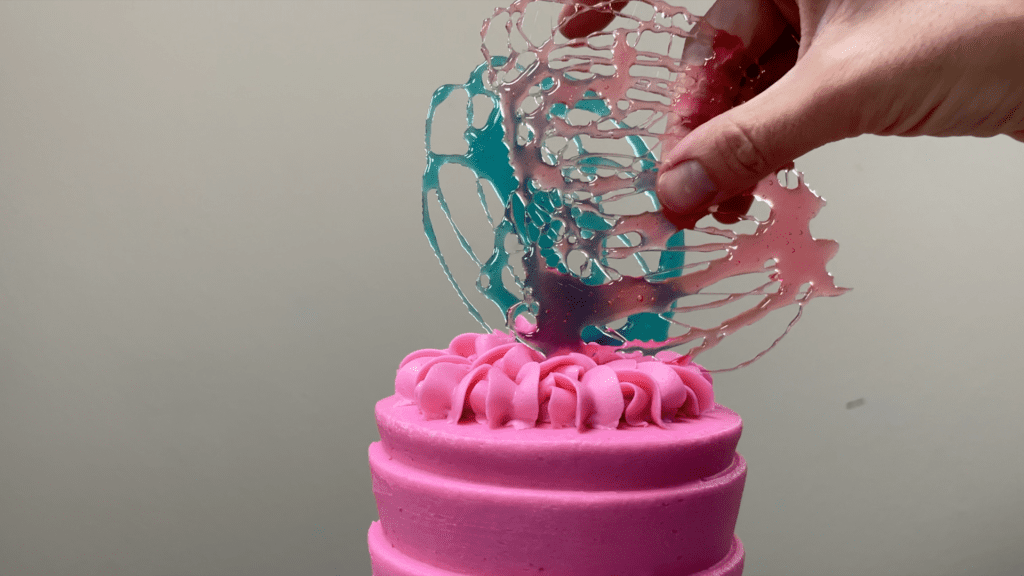 push sugar candy cake toppers into frosting on cake 5 Cakes You Can Decorate in 5 Minutes