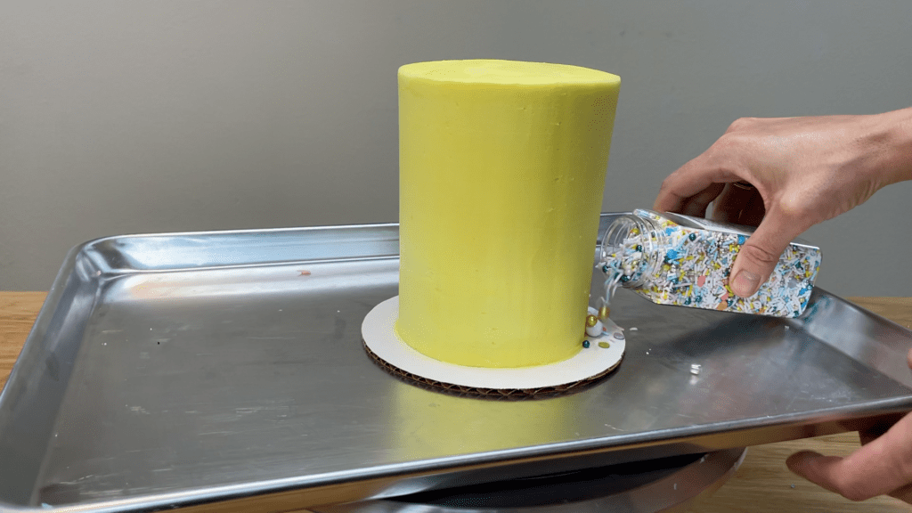 put cake on tray and pour sprinkles onto cake board to make a sprinkle border 5 Cakes You Can Decorate in 5 Minutes